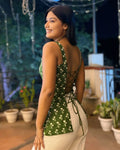 Green floral crop top with lace-up back paired with white pants, elegant fusion wear for women.